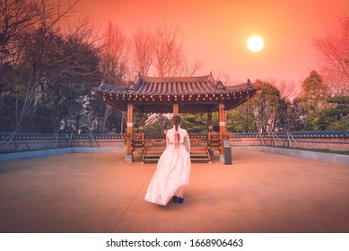 Asian Korean Girls Dressed Hanbok In Traditional Dress At Sunset In South Korea.