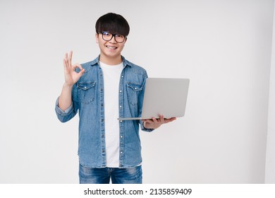 Asian Korean Young Coder Programmer Student Man Freelancer Hacker Working Remotely On Laptop, Doing Online Shopping, E-learning On Distance, Browsing Showing Okay Isolated On White Background