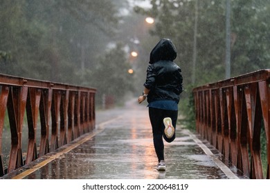 Asian ladies running in the rain  - Powered by Shutterstock