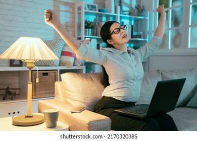 Asian Lady In Formal Clothes Spreading Her Arms Wide And Breathing A Sigh Of Relief For She Finally Completed Her Work. Portrait Of Chinese Woman Working Overtime Is Making Ah Sound While Stretching