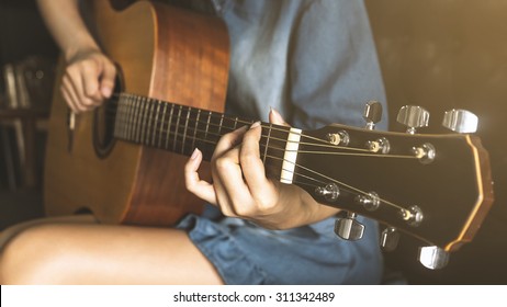 Asian Lady Playing Guitar With Vintage Look