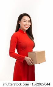 Asian Lady In Red Ao Dai Traditional Dress Suit Holding Carton Gift Box In The Lunar New Year