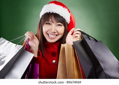 Asian Lady With Red Christmas Outfit Holding Lots Of Shopping Bags