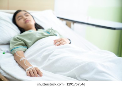 Asian lady sleep and patient in hospital with iv solution, this immage can use for flu, sick, health, medical and medicine concept
