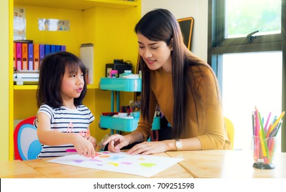 Asian lady teacher teach about drawing and art subject to her student on table in class room in preschool, education, school, teacher, kid snd student concept