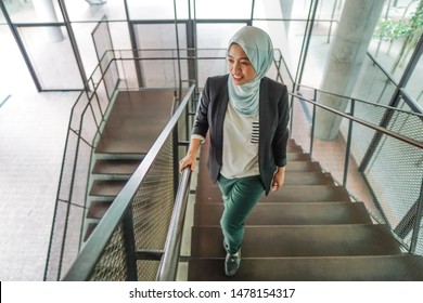 Asian lady walking at the stairs