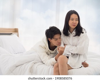 Asian Lesbian Couple Trying To Make Up After Argument On The Bed In The Bedroom. Family Bonding And Happiness.