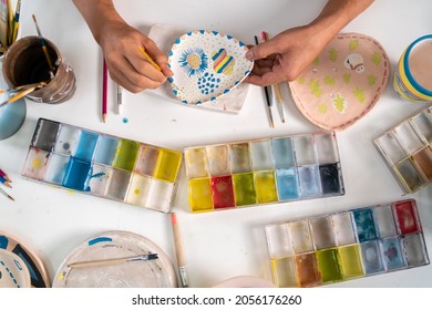 Asian LGBTQ guy learning color painting her self  made pottery at home  Confidence female enjoy hobbies   indoors leisure activity handicraft ceramic sculpture   painting workshop at pottery studio