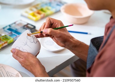 Asian LGBTQ guy learning color painting self-made pottery mug with friends at home. Confidence male enjoy handicraft activity lifestyle hobbies ceramic sculpture painting workshop at pottery studio - Shutterstock ID 2109507560