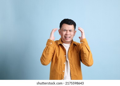 The Asian LGBTQ Man With Yellow Shirt Standing On The Blue Background.