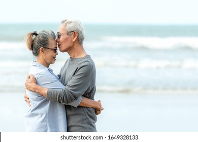 Asian Lifestyle senior couple hug and kiss on the beach happy in love romantic and relax time.  People tourism elderly family travel leisure and activity after retirement in vacations and summer. - Powered by Shutterstock
