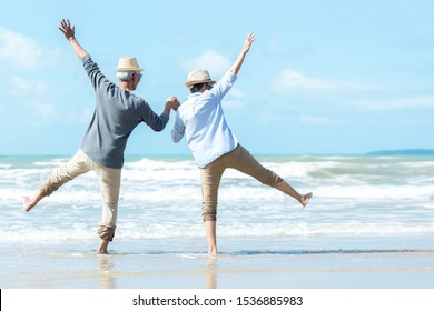 Asian Lifestyle senior couple jumping on the beach happy in love romantic and relax time.  Tourism elderly family travel leisure and activity after retirement in vacations and summer. - Powered by Shutterstock