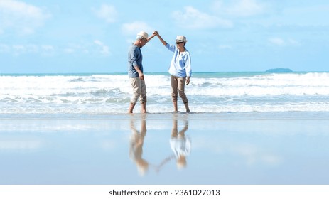 Asian Lifestyle senior couple walking and dancing chill on the beach happy in love romantic and relax time after retirement.  People tourism elderly family travel leisure and activity in vacations - Powered by Shutterstock