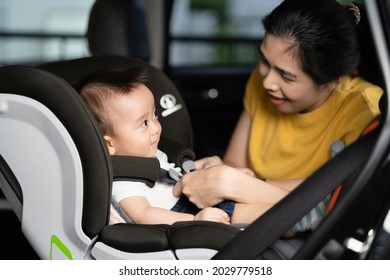 Asian Little Baby Happy And Fun While Fastened Belt And Seat In The Safety Car Seat. A Boy Looking His Mother And Smile In