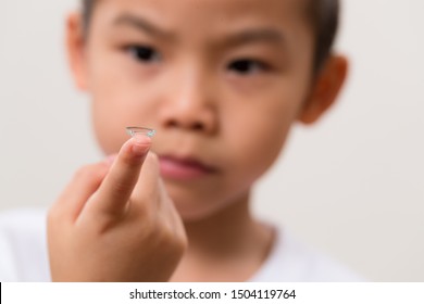 Asian Little Boy Hold A Contact Lens