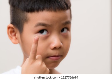 Asian Little Boy Put A Contact Lens On A Finger