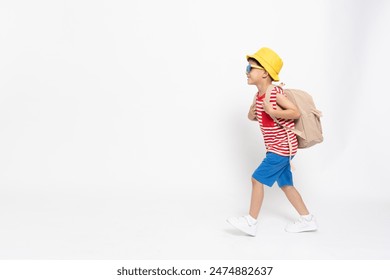 Asian little boy in red striped shirt summer outfits with yellow hat walking with backpack isolated on white background, Six years old - Powered by Shutterstock