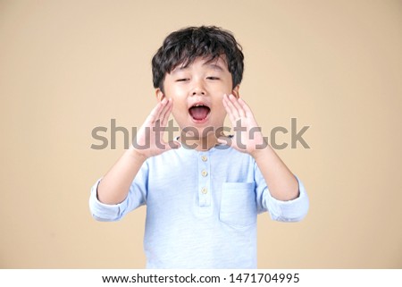 Asian little boy shout with happy wow surprised face