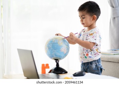 Asian Little Boy Student Study Geography And Language Art Online Learning Class At Home. Concept Of New Normal In Covid-19 Coronavirus Pandemic.