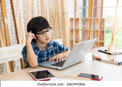 Asian little boy who dreams of being a decorator with laptop.
