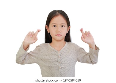 Asian Little Child Girl Holding Fingers Crossed Isolated On White Background