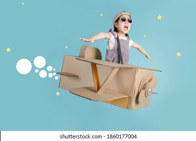 Asian little child girl playing with cardboard toy airplane handicraft isolated on blue long banner with copy space for your text, Creative with family and dreaming of flying concept