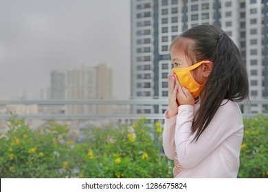 Asian Little Child Girl Wearing A Protection Mask Against PM 2.5 Air Pollution In Bangkok City. Thailand.