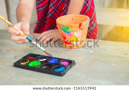 Asian little child for painting pot activity in holiday family 