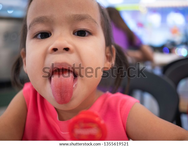 Asian Little Child Show Her Tongue Stock Photo (Edit Now) 1355619521