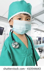 Asian Little Chinese Girl Playing a Doctor with Mask and Stethoscope in Surgery Room