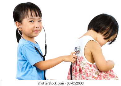 Asian Little Chinese Girls Playing as Doctor and Patient with Stethoscope isolated on white background