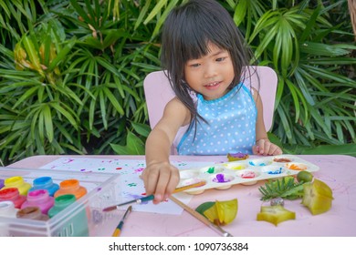 Asian Little Cute Girl Using Different Shapes From Nature As Painting Tools.Painting Is Play Therapy For ADHD Kids (Attention Deficit Hyperactivity Disorder),can Be Used To Address Emotional Problems.