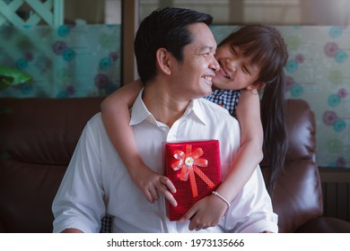 Asian Little Daughter Congratulating Dad And Giving Him Gift Box With Smiling And Hugging.Concept Of Happy Father's Day