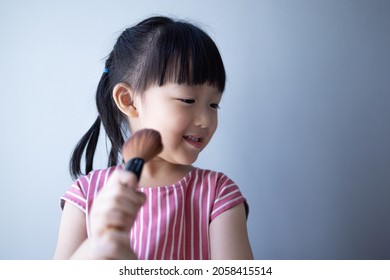 Asian Little Daughter Doing Make Up Herself. Concept Of Beauty And Cosmetic For Kid.