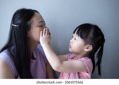 Asian Little Daughter Doing Make Up Her Mom. Concept Of Love And Connection Of Mother And Kid.