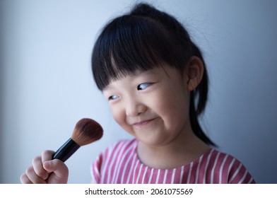 Asian Little Daughter Doing Make Up Herself. Concept Of Beauty And Cosmetic For Kid.