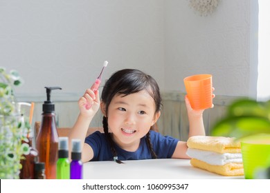 Asian Little Girl Brushing Teeth