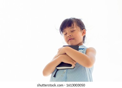 Asian Little Girl Close Her Eyes Holding Bible Book  Hands Folded Praying  On White Bacground , Kid Prayer Hands Pray In Church , Spirituality Religion Concept 