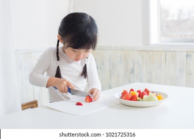 Asian Little Girl Cooking