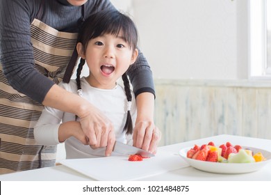 Asian Little Girl Cooking With Mom