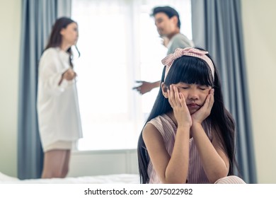 Asian Little Girl Crying While Parents Fighting Or Quarrel Conflict. Young Kid Daughter Sit On Bed Feel Heart Broken With Tears And Dont Want To See Violence At Home. Family Problem-separation Concept