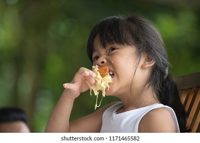 Asian Little Girl Eating Durian Fruit.