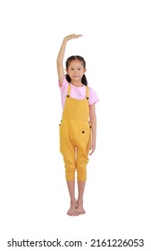 Asian Little Girl Kid Measures The Growth Isolated Over White Background. Child Estimate Her Height By Hand