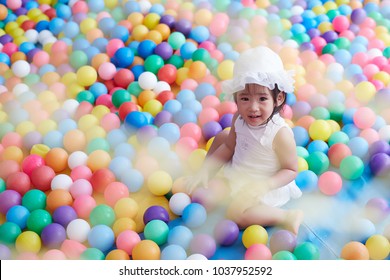 Asian Little Girl Play With Very Colorful Ball 