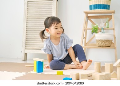 Asian Little Girl Playing With Building Blocks