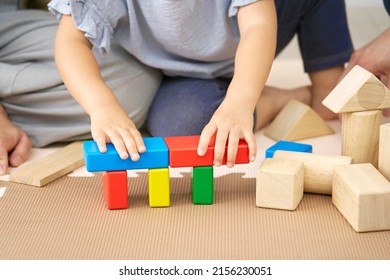 Asian little girl playing with the building blocks at home, no face