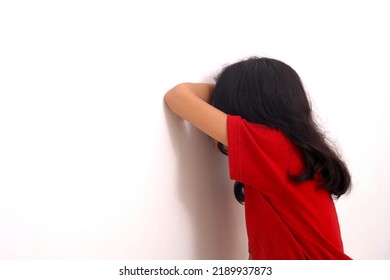 Asian Little Girl Playing Hide And Seek. Asian Little Girl Crying On The Wall. Isolated On White