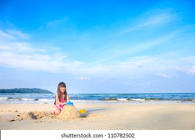 Asian Little Girl Playing Sand On The Beach