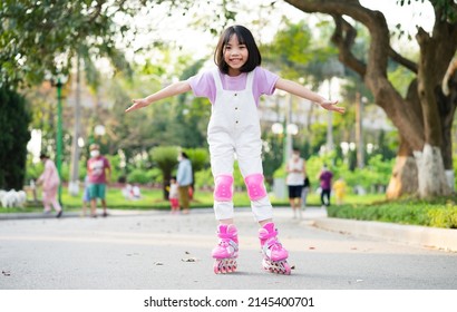 Asian Little Girl Practicing Roller Skating In The Park