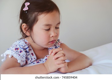 Asian Little Girl Praying On The Bed, Kid, Child Prayer, World Day Of Prayer,international Day Of Prayer